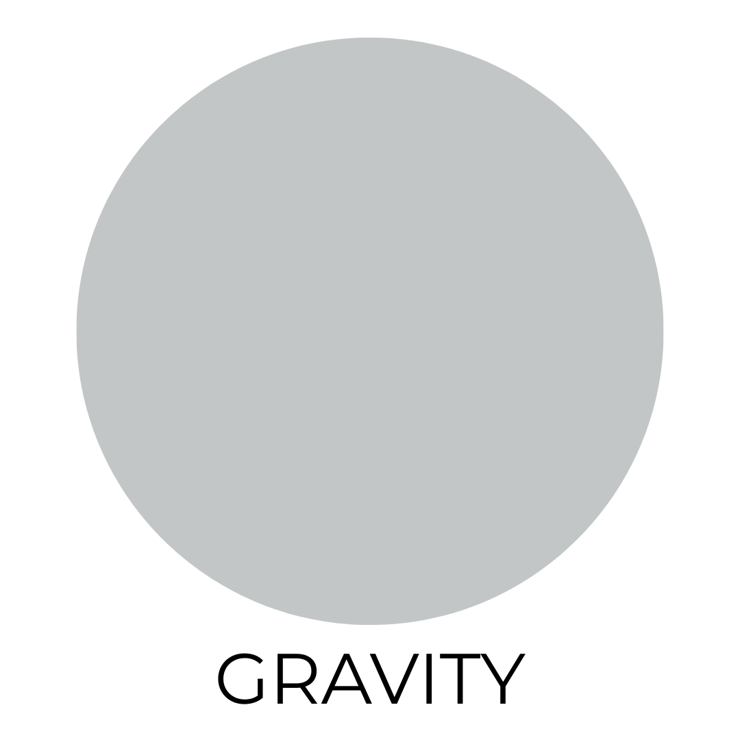A digital paint swatch showing Valspar’s Gravity. The swatch features a cool, silvery greige tone displayed in a large, centered circle on a white background. Below the circle, the name “GRAVITY” is written in clean, black, all-caps text.