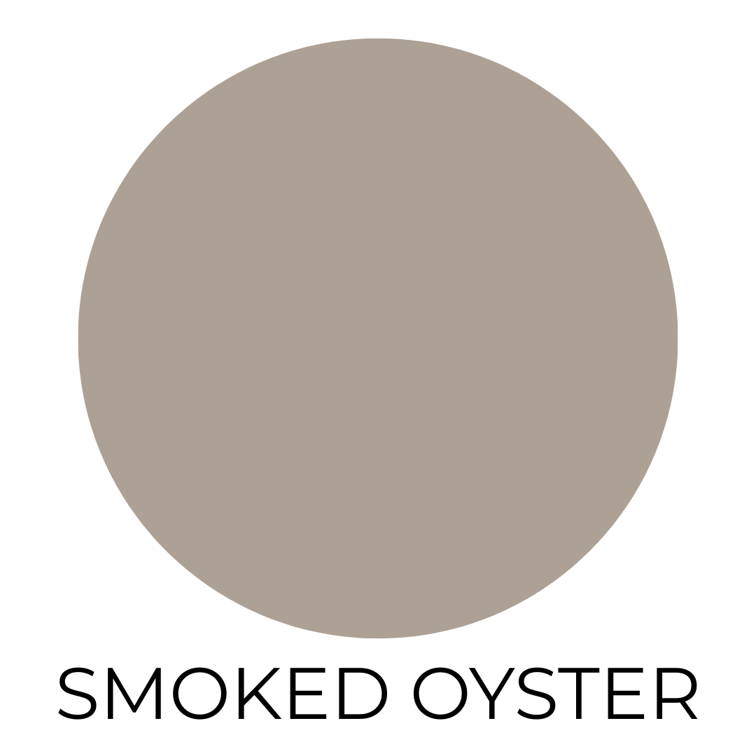 A digital paint swatch featuring Behr’s Smoked Oyster, a warm, medium-toned greige with taupe and mushroom undertones. The color is shown as a smooth circular sample centered on a white background. Below the swatch, the name “SMOKED OYSTER” is written in clean, black, all-capital letters.