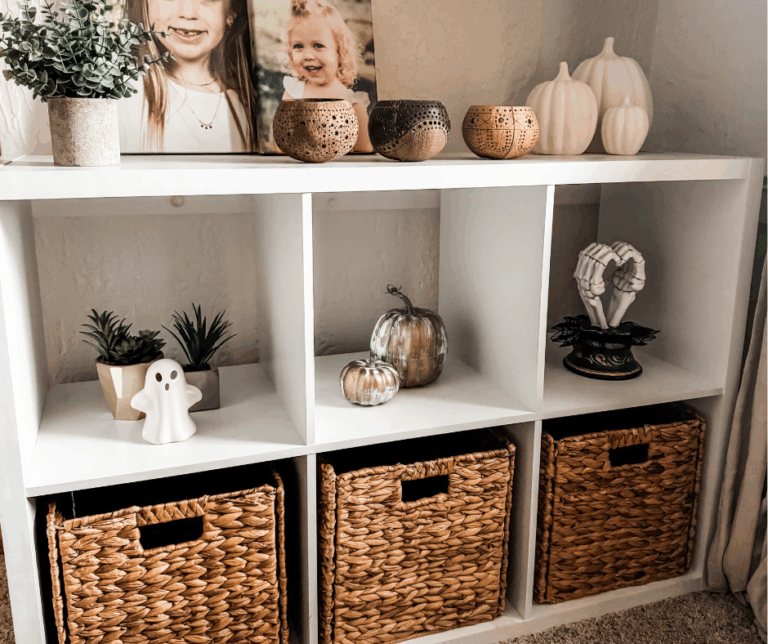 Minimalist Halloween decor on a white cube shelf