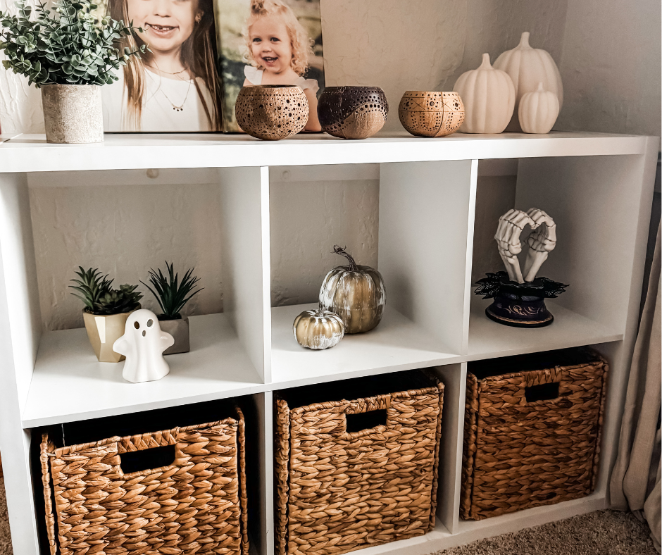 Minimalist Halloween decor on a white cube shelf