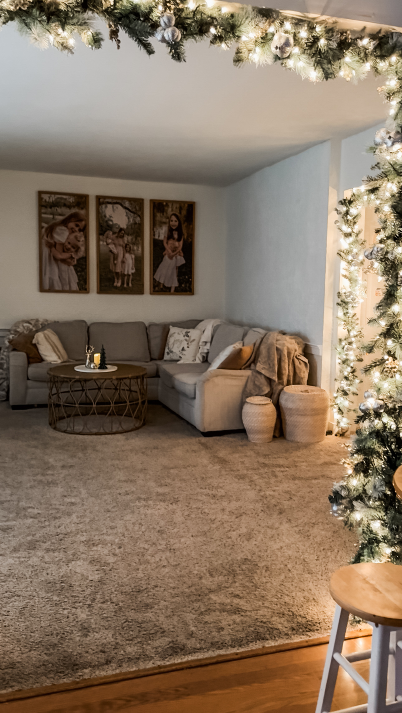 Minimal neutral Christmas corner with greenery and soft seasonal accents styled in a calm, earthy palette.