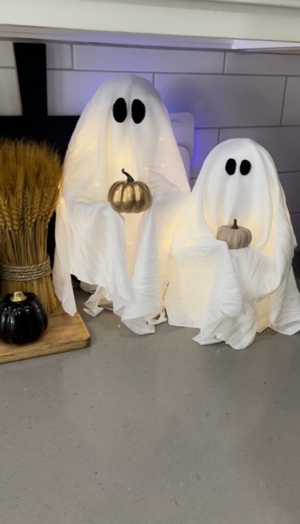 Easy diy Halloween decor ghosts holding pumpkins.