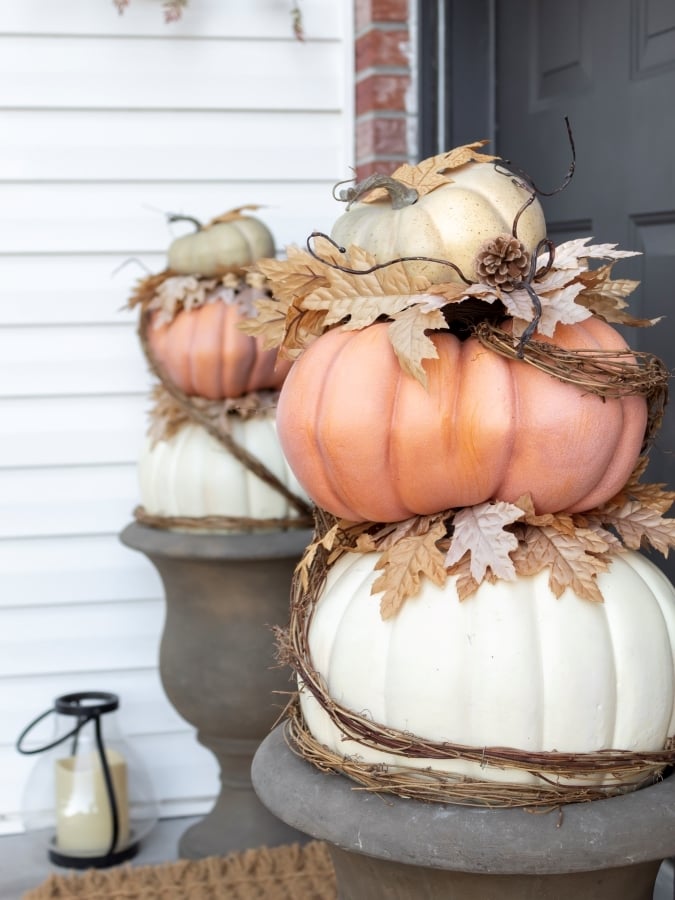 DIY stacked pumpkins with faux leaves and wrapped in twine.